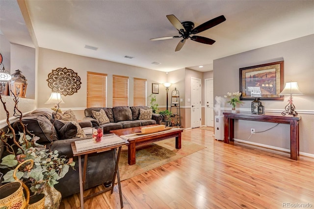 living room featuring ceiling fan and light hardwood / wood-style floors