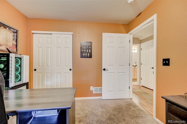 office featuring carpet and a textured ceiling