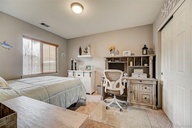 carpeted bedroom featuring a closet