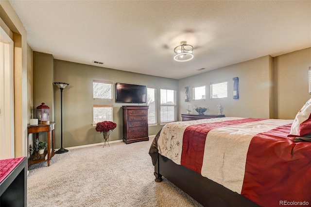 bedroom with carpet floors and a textured ceiling