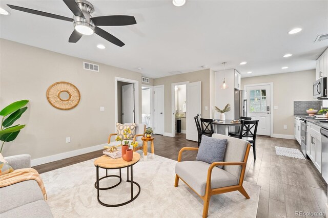 1655 N Yates St, Denver, CO 80204 - living area with wood finished floors, a ceiling fan, and recessed lighting