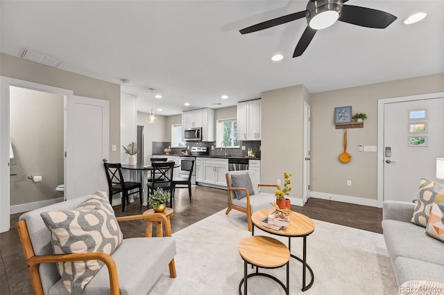 1655 N Yates St, Denver, CO 80204 - living area featuring dark wood finished floors, a ceiling fan, and recessed lighting