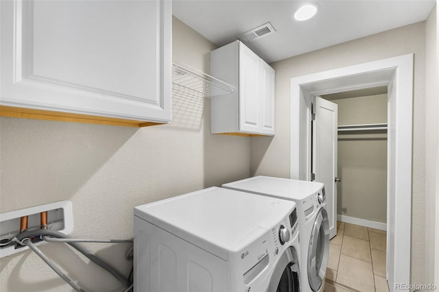 1655 N Yates St, Denver, CO 80204 - laundry room featuring washer and clothes dryer, cabinet space, and light tile patterned floors