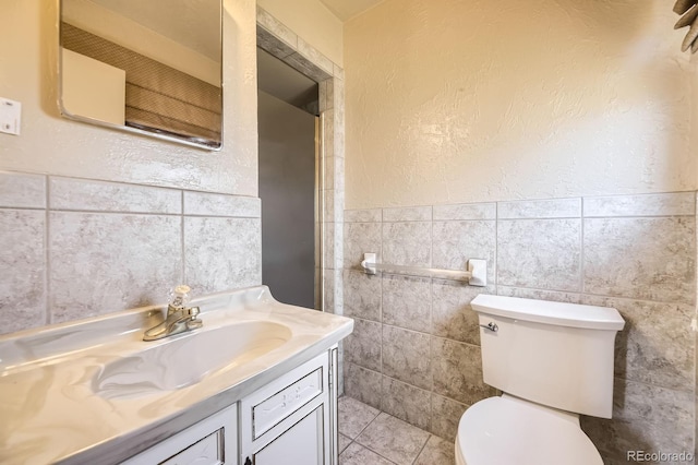 6710 W Nevada Pl, Lakewood, CO 80226 - bathroom with tile walls, vanity, and wainscoting