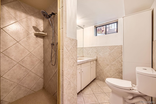 6710 W Nevada Pl, Lakewood, CO 80226 - bathroom featuring tile walls, vanity, tile patterned floors, and a tile shower