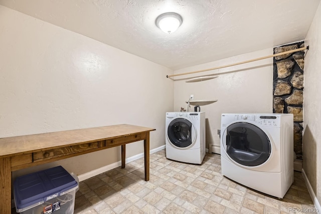 6710 W Nevada Pl, Lakewood, CO 80226 - washroom featuring washing machine and clothes dryer, stone finish flooring, a textured ceiling, and a baseboard radiator