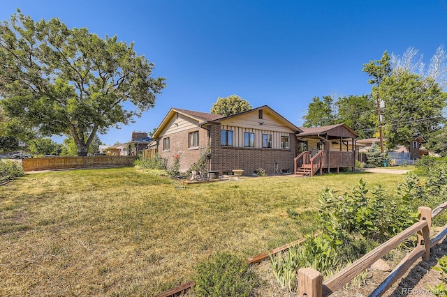 6710 W Nevada Pl, Lakewood, CO 80226 - rear view of house with a wooden deck and brick siding