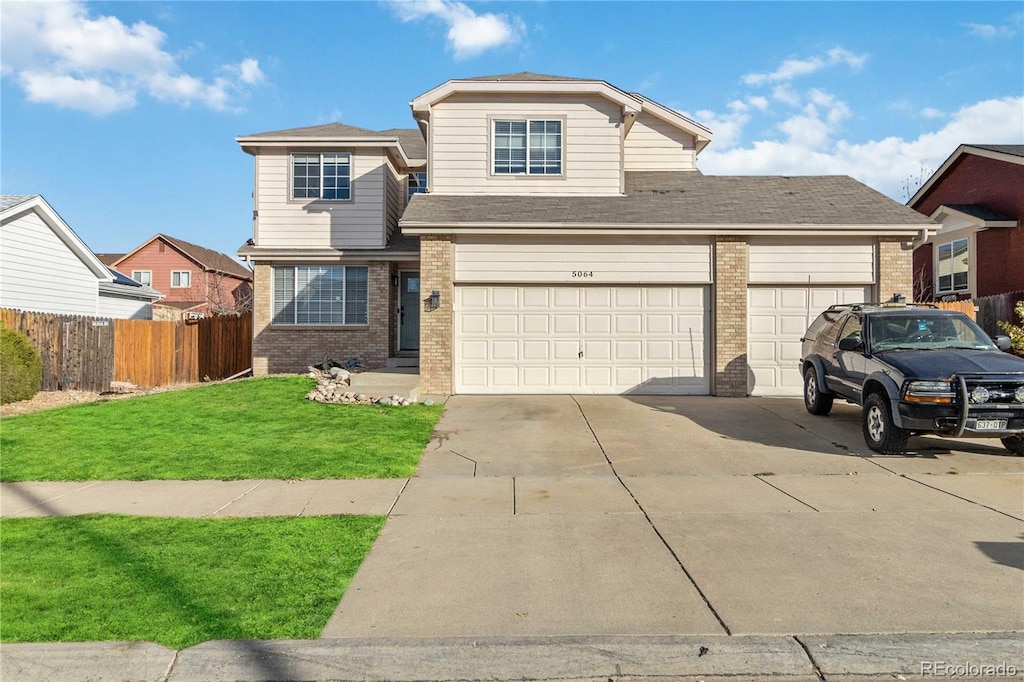 view of front property with a garage and a front lawn