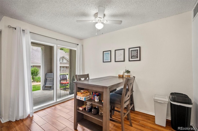 dining area featuring ceiling fan, a textured ceiling, and light wood-type flooring