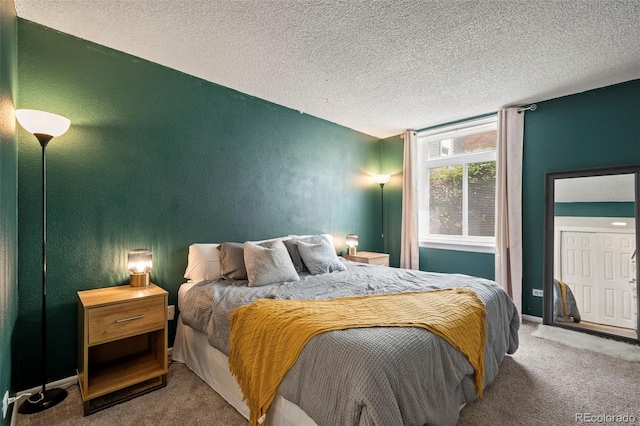 carpeted bedroom featuring a textured ceiling