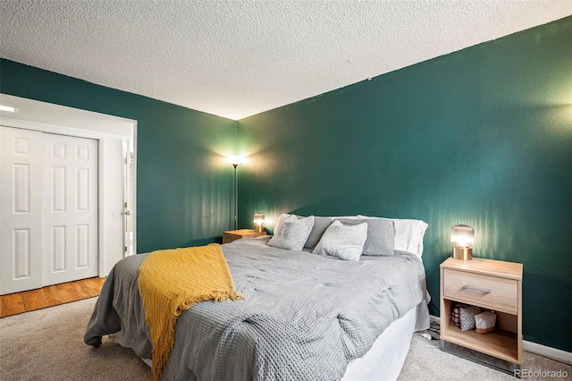 carpeted bedroom featuring a textured ceiling