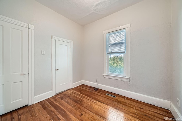 spare room with hardwood / wood-style flooring