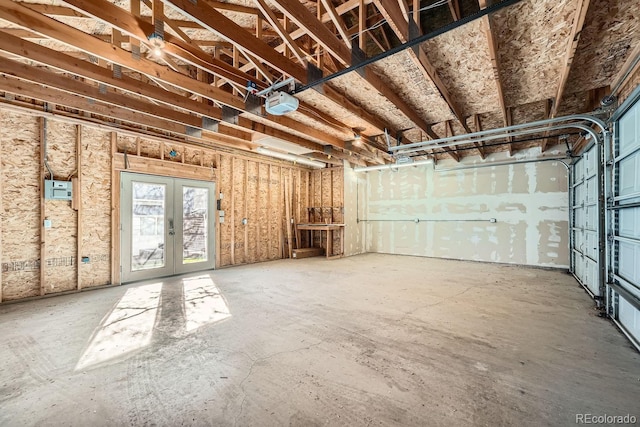 garage with a garage door opener and french doors