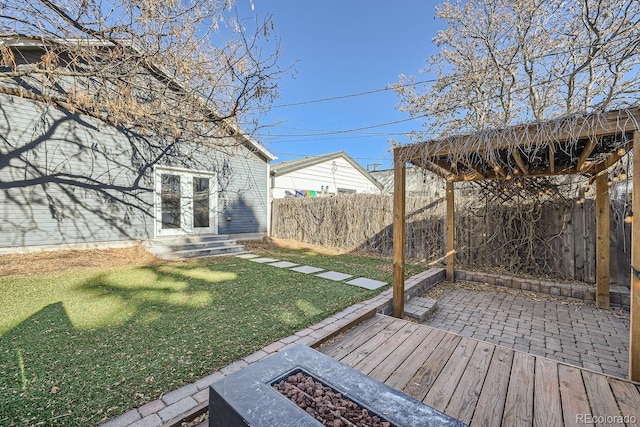 view of yard with a patio and an outdoor fire pit