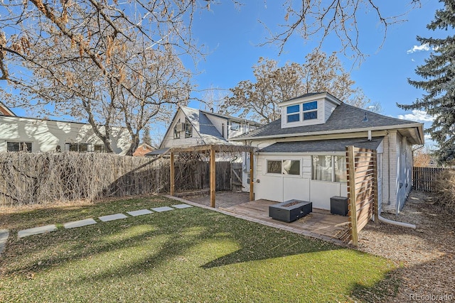 rear view of house featuring an outdoor structure and a lawn