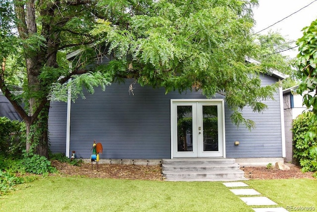 exterior space with a yard and french doors