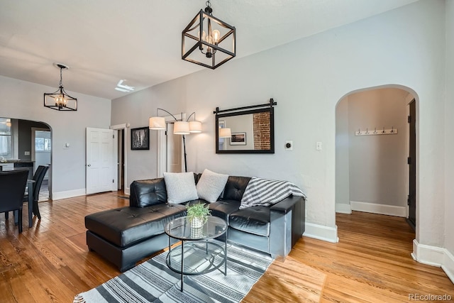 living room featuring an inviting chandelier and light wood-type flooring