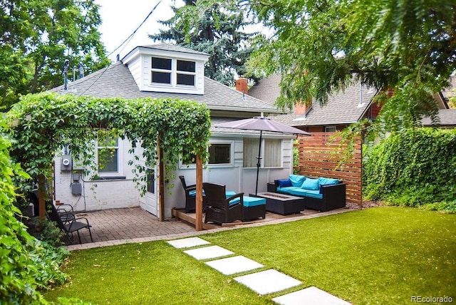 back of property featuring a yard, outdoor lounge area, and a patio