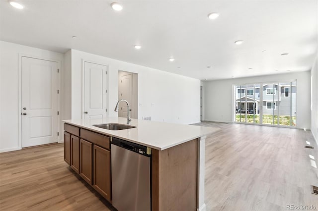 18951 E 96th Pl, Commerce City, CO 80022 - kitchen featuring stainless steel dishwasher, light wood-style floors, light countertops, a center island with sink, and recessed lighting