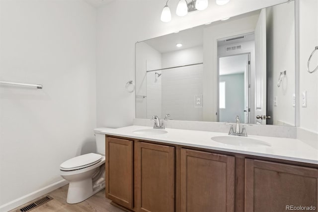 18951 E 96th Pl, Commerce City, CO 80022 - bathroom featuring double vanity, wood finished floors, and a tile shower