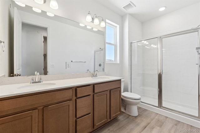 18951 E 96th Pl, Commerce City, CO 80022 - full bath with double vanity, a stall shower, and wood finished floors