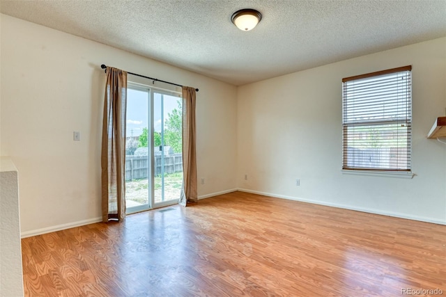 5831 Moon Ridge Dr, Colorado Springs, CO 80922 - empty room with light wood-style flooring, a textured ceiling, and baseboards