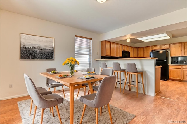 5831 Moon Ridge Dr, Colorado Springs, CO 80922 - dining space featuring light wood finished floors and baseboards