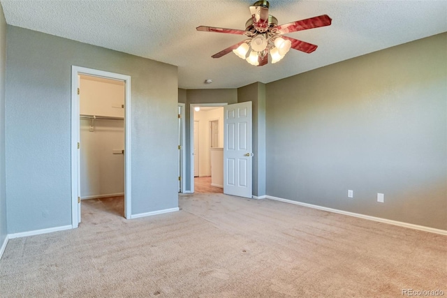5831 Moon Ridge Dr, Colorado Springs, CO 80922 - unfurnished bedroom featuring carpet, a spacious closet, baseboards, a closet, and a textured ceiling