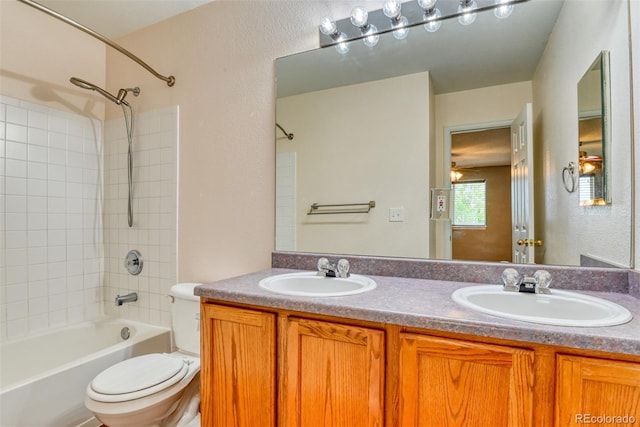 5831 Moon Ridge Dr, Colorado Springs, CO 80922 - bathroom featuring toilet, shower / bathtub combination, and double vanity