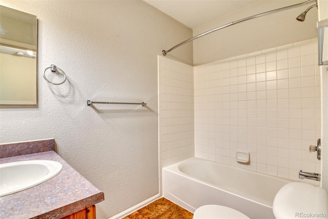 5831 Moon Ridge Dr, Colorado Springs, CO 80922 - bathroom with toilet, vanity, bathtub / shower combination, a textured wall, and baseboards