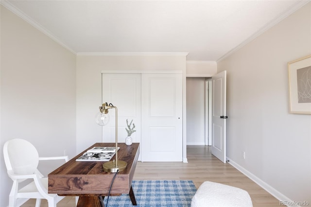 office with crown molding and light hardwood / wood-style flooring