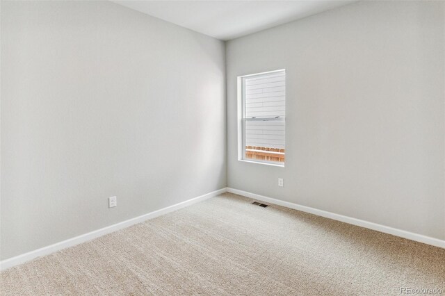 unfurnished room with light carpet, baseboards, and visible vents