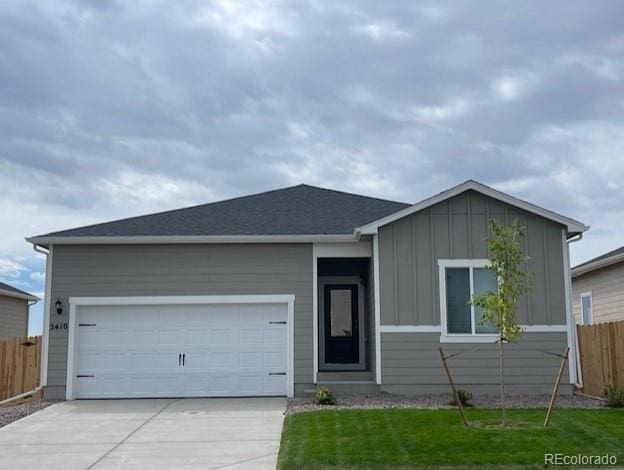 ranch-style home with driveway, fence, and board and batten siding