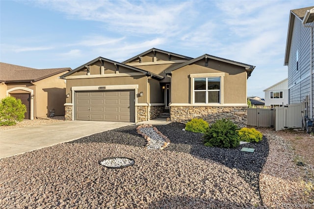 8895 Vanderwood Rd, Colorado Springs, CO 80908 - craftsman inspired home with stucco siding, stone siding, concrete driveway, an attached garage, and a gate
