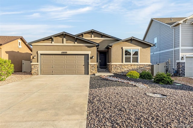 8895 Vanderwood Rd, Colorado Springs, CO 80908 - view of front of property with stone siding, stucco siding, a garage, and concrete driveway