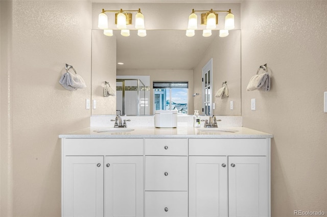 8895 Vanderwood Rd, Colorado Springs, CO 80908 - full bath featuring double vanity, a textured wall, and a stall shower