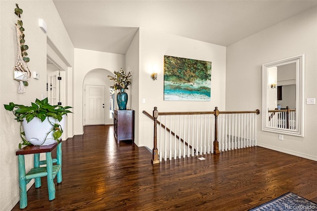 8895 Vanderwood Rd, Colorado Springs, CO 80908 - hall with an upstairs landing, arched walkways, and wood finished floors
