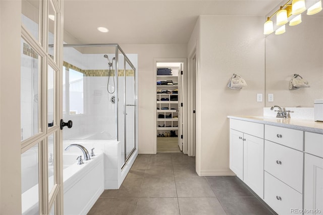8895 Vanderwood Rd, Colorado Springs, CO 80908 - bathroom featuring vanity, a bath, a stall shower, a spacious closet, and tile patterned floors