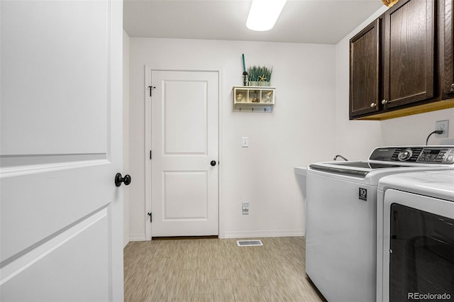 8895 Vanderwood Rd, Colorado Springs, CO 80908 - washroom with cabinet space, washing machine and clothes dryer, and light wood-style floors