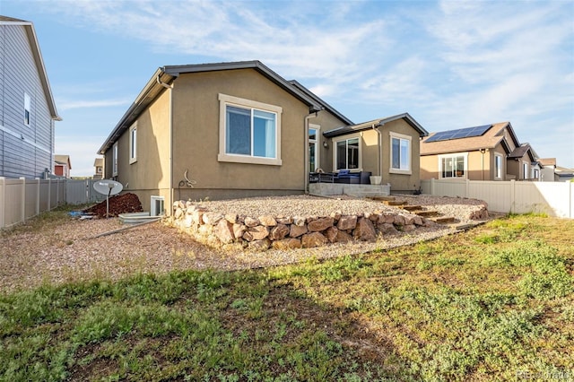 8895 Vanderwood Rd, Colorado Springs, CO 80908 - back of property with a fenced backyard and stucco siding