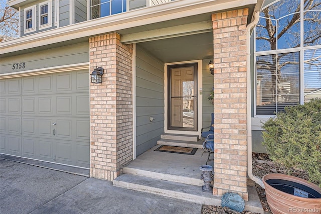 property entrance with brick siding and an attached garage