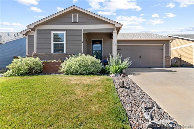 115 Quandary Ave, Berthoud, CO 80513 - view of front of house with brick siding, concrete driveway, a garage, and a front lawn