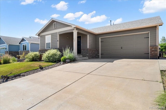 115 Quandary Ave, Berthoud, CO 80513 - view of front of home with brick siding, an attached garage, driveway, and a front lawn