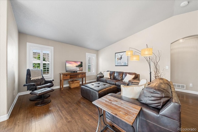 115 Quandary Ave, Berthoud, CO 80513 - living area featuring vaulted ceiling, dark wood-style floors, and arched walkways