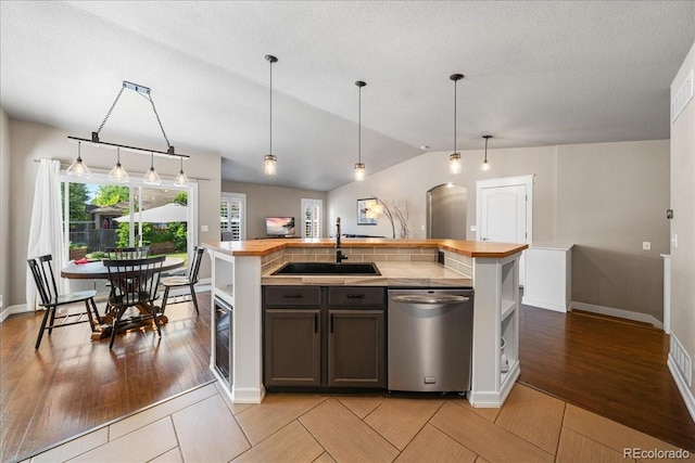 115 Quandary Ave, Berthoud, CO 80513 - kitchen featuring dishwasher, wood counters, light wood-type flooring, vaulted ceiling, and pendant lighting