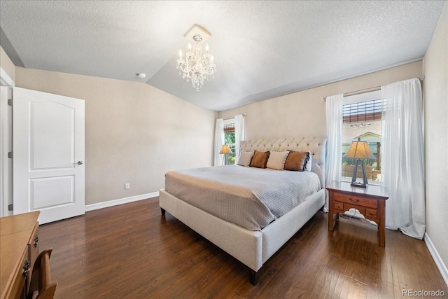 115 Quandary Ave, Berthoud, CO 80513 - bedroom with dark wood-type flooring, a chandelier, vaulted ceiling, and a textured ceiling