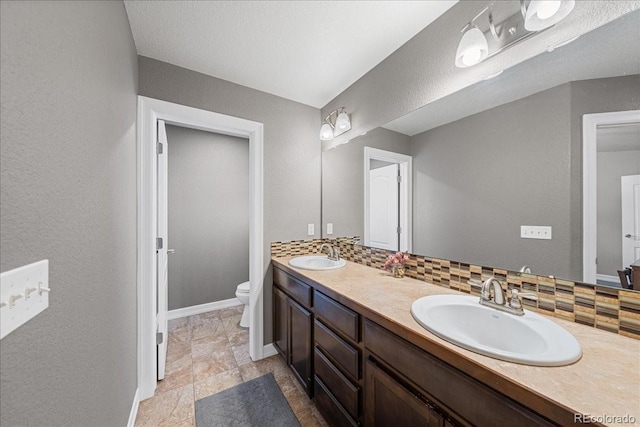 115 Quandary Ave, Berthoud, CO 80513 - bathroom featuring double vanity and decorative backsplash