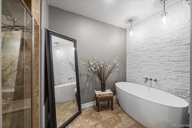 115 Quandary Ave, Berthoud, CO 80513 - full bath featuring a stall shower, a freestanding tub, and a textured ceiling