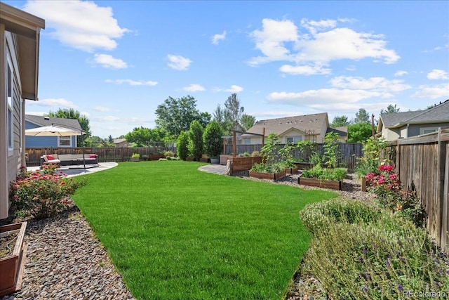 115 Quandary Ave, Berthoud, CO 80513 - fenced backyard featuring a vegetable garden, outdoor lounge area, and a patio
