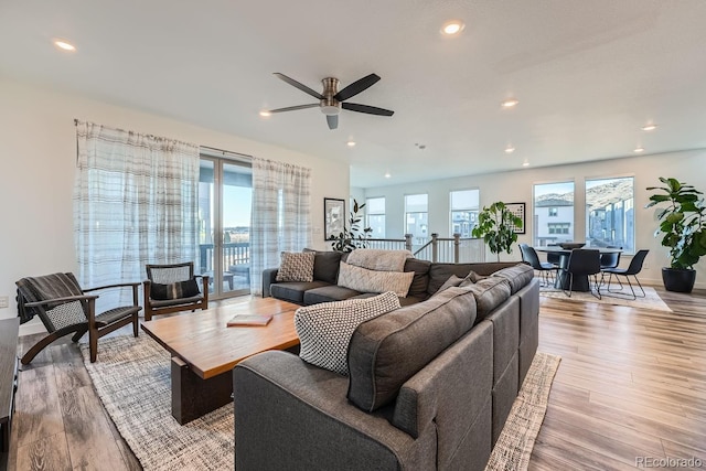 living area with plenty of natural light, wood finished floors, and recessed lighting